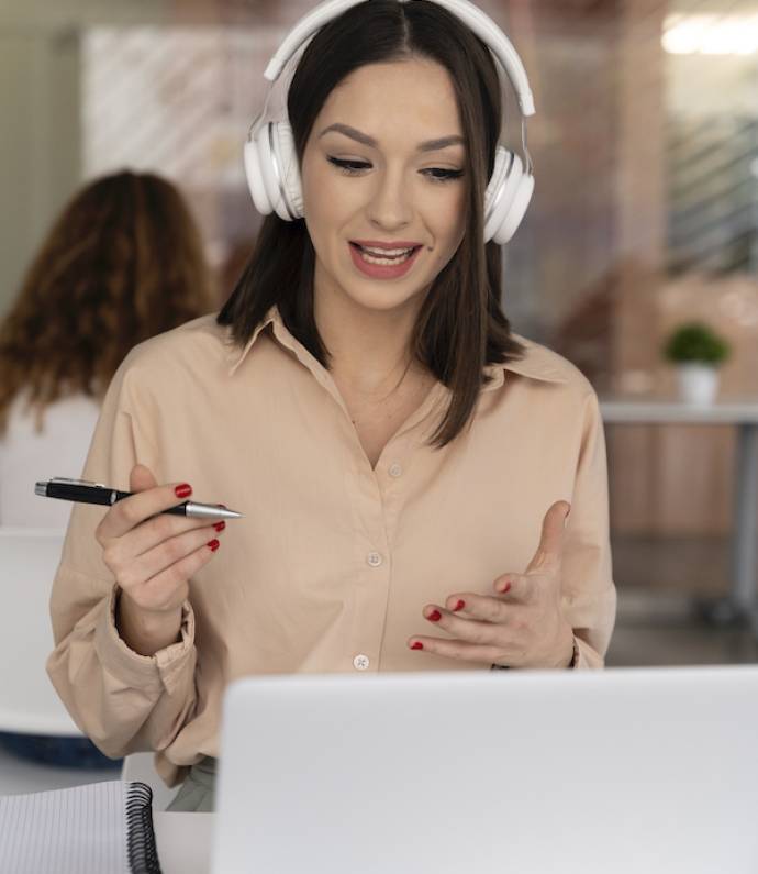 young-business-woman-working-office-with-laptop-headphones